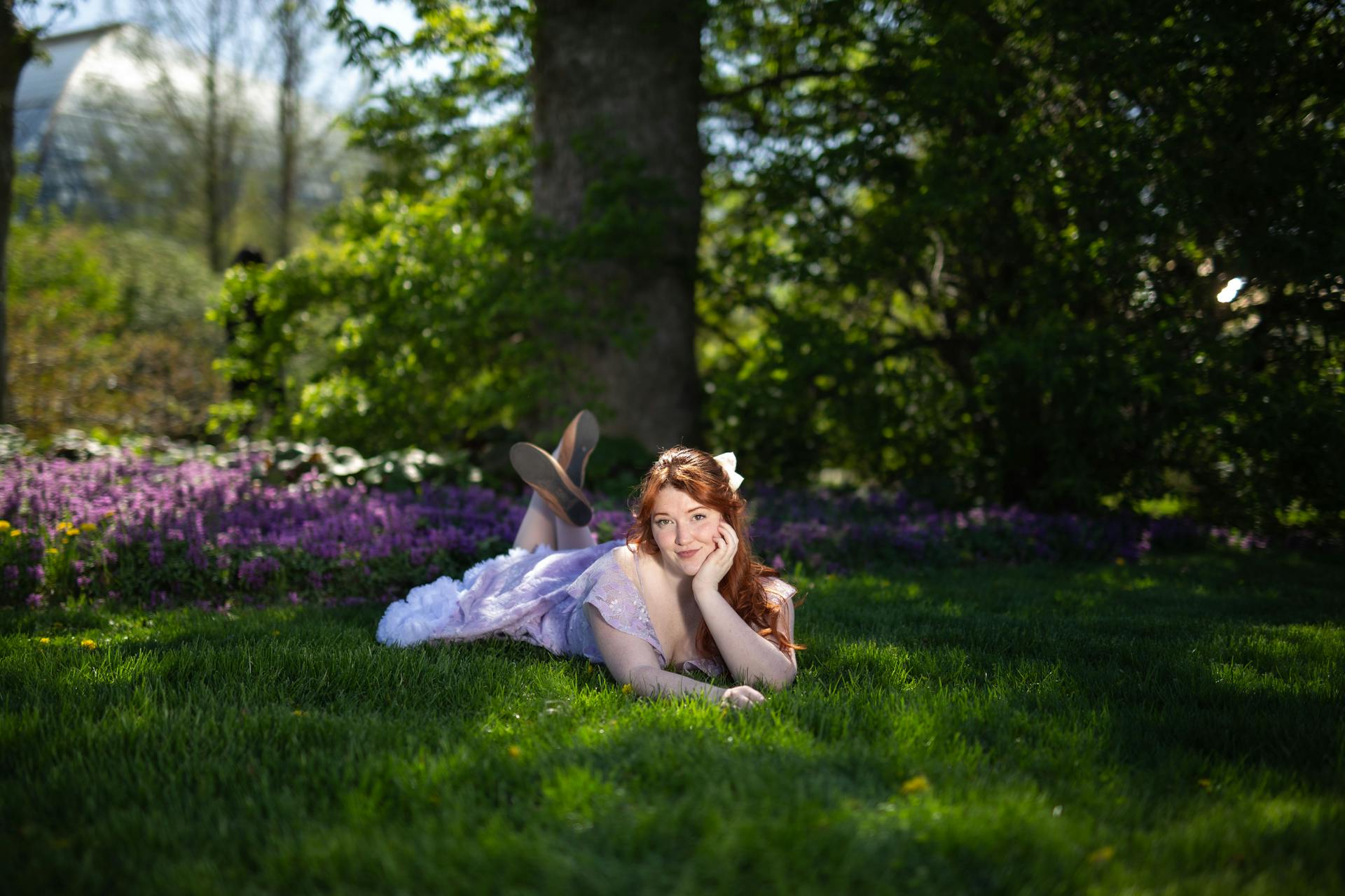 Woman in Purple Dress Lying Down on Grass