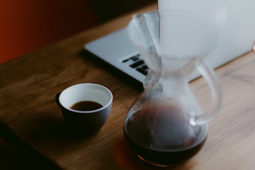 Free Clear Glass Pitcher Beside Black Ceramic Teacup Stock Photo