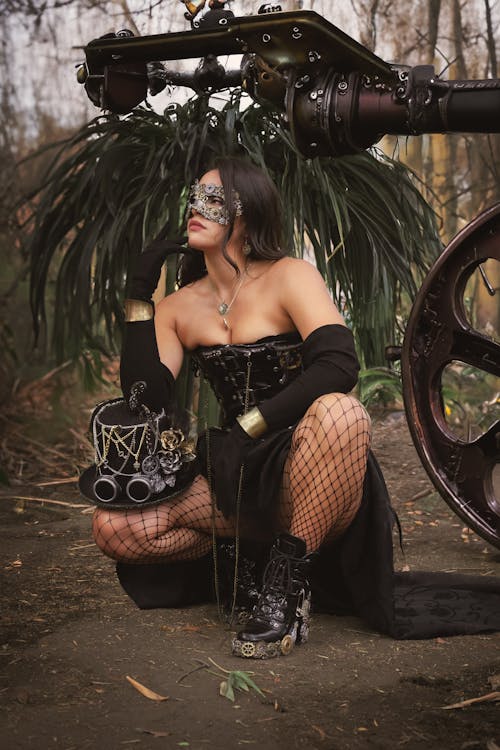 A woman in a steampunk costume sitting on a bench