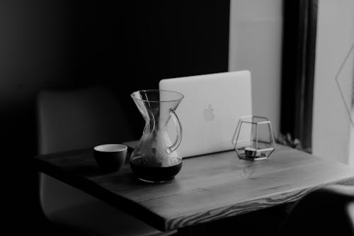 Macbook White Beside Clear Glass Pitcher