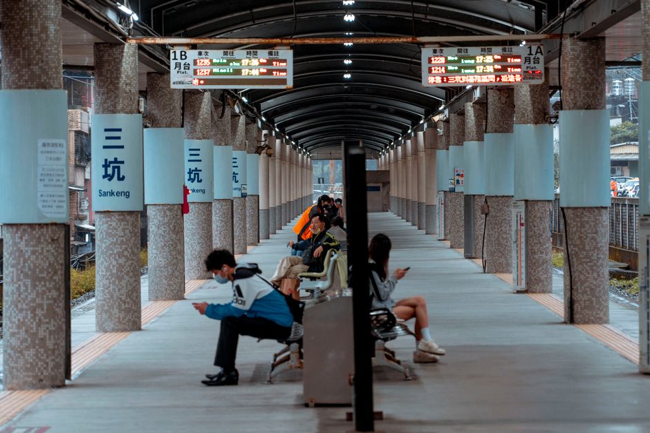 Hand holding an EasyCard at a Taipei MRT station in Taiwan