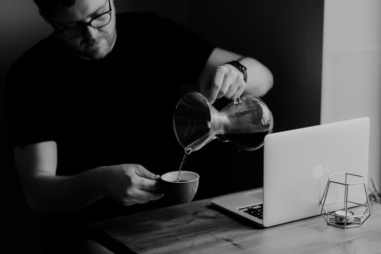 Man Pouring Liquor Into Cup