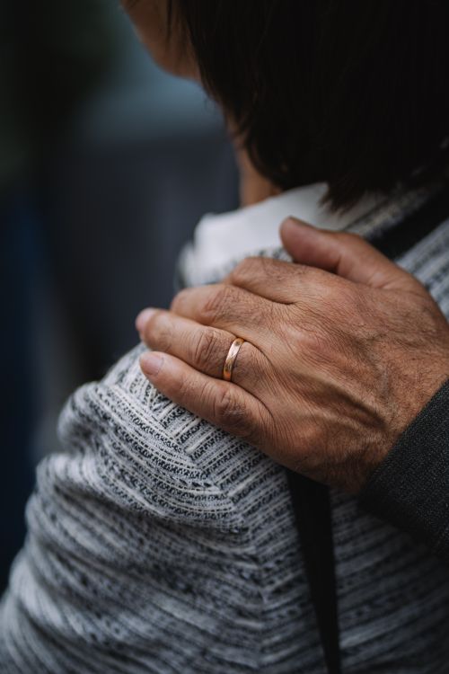 Free Close-up of a hand gently resting on a shoulder, symbolizing care and support. Stock Photo