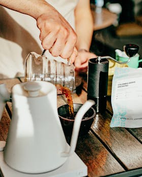 A barista pours freshly brewed coffee into a cup in a cozy café in Baku, Azerbaijan.