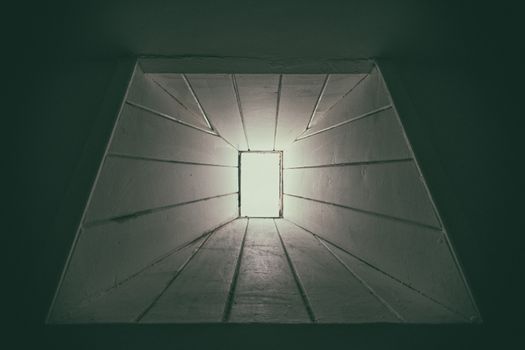 Abstract view of geometric design with dramatic lighting, creating a tunnel-like visual effect.