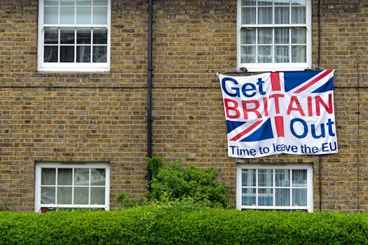 Brick home displaying Brexit protest sign with Union Jack design.