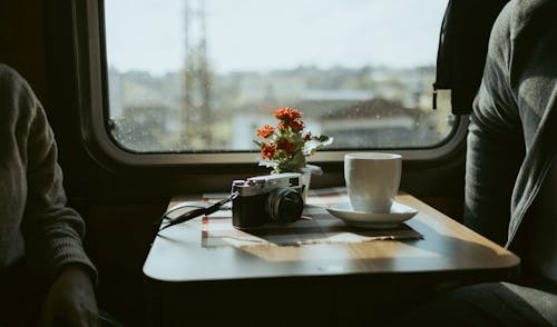 A person sitting at a table with a cup of coffee