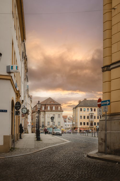 A street with cars parked on it at sunset