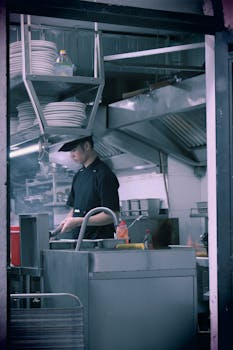 Chef preparing food in a modern restaurant kitchen, showcasing professional culinary environment.