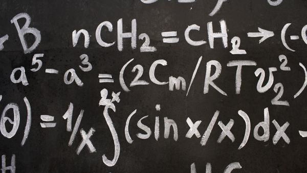 Close-up of complicated equations written on a blackboard