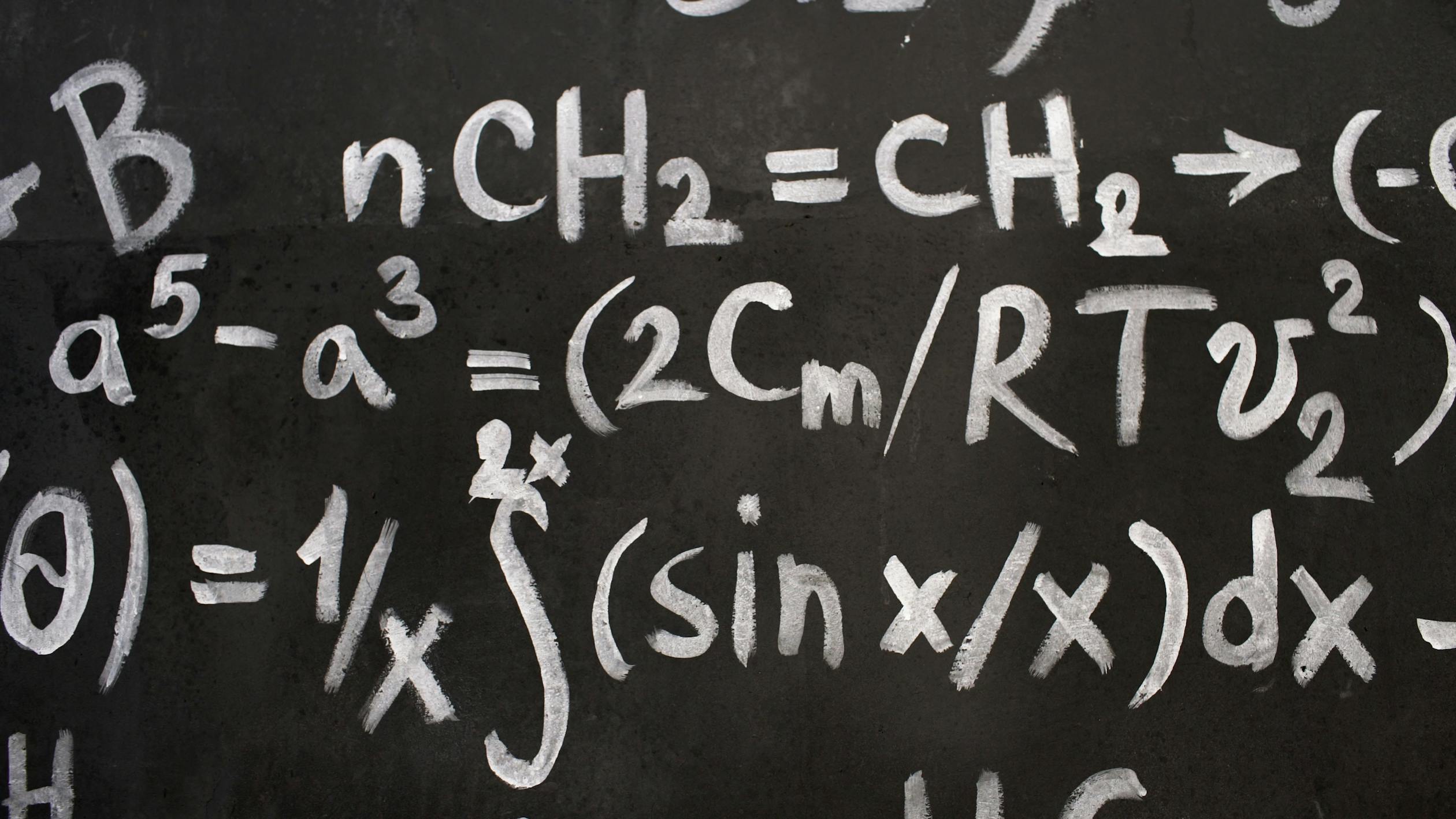 Free Close-up of complex equations on a chalkboard, showcasing chemistry and math symbols. Stock Photo