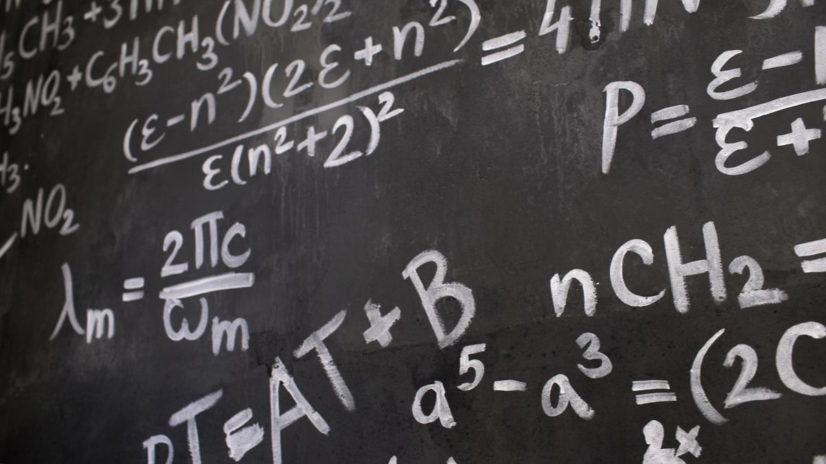 Complex equations and formulas written on a blackboard