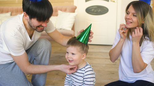 Free Happy family celebrating with birthday hats indoors. Fun and joyful moment together. Stock Photo