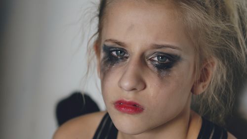 Free Close-up portrait of a woman with messy makeup and tears, conveying deep emotion. Stock Photo