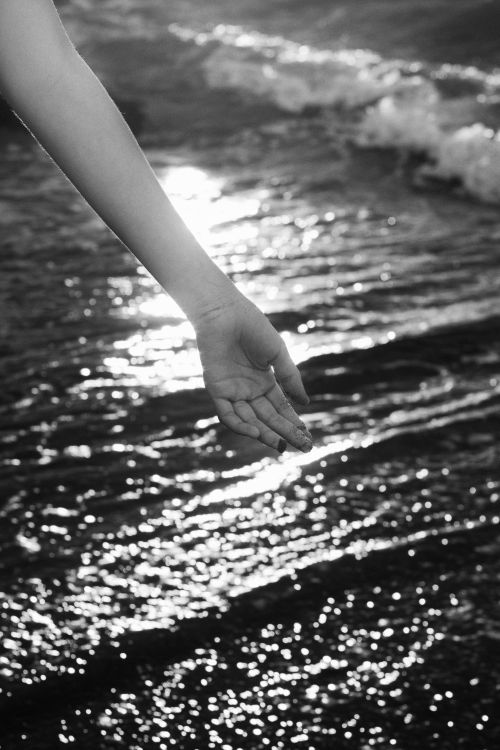 Hand Sign Water Wave Hand with Marks Hanging over Wavy Water with Reflection · Free Stock Photo