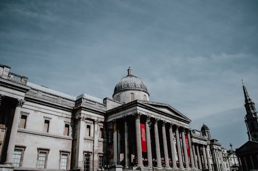 The National Gallery in London, a famous architectural landmark, captured under a clear sky.