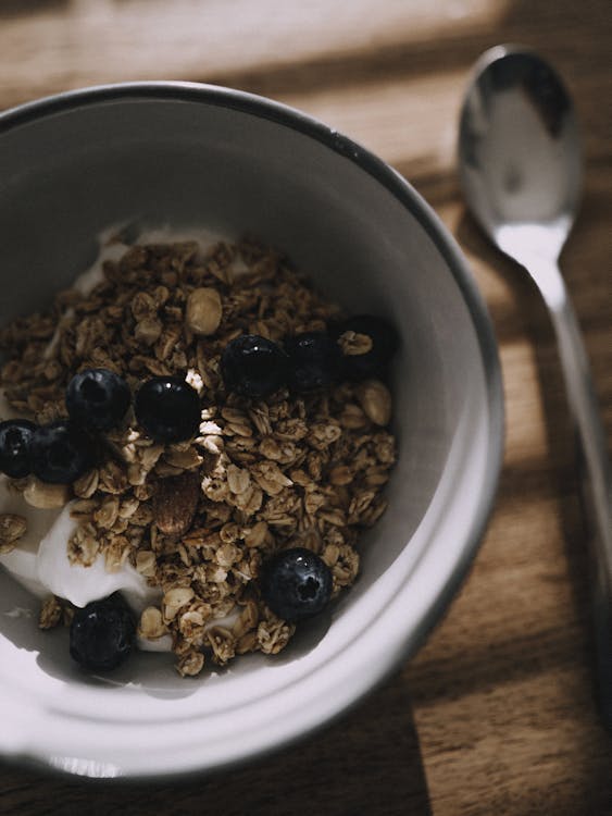 A bowl of granola with blueberries and yogurt