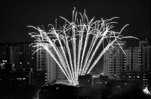 Black and white photo of fireworks over city