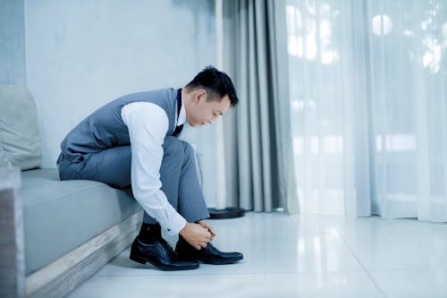 Free Photo of Man Tying His Shoes Stock Photo