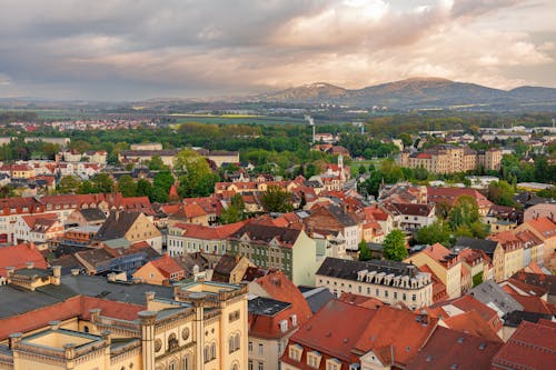 A city with red roofs and mountains in the background