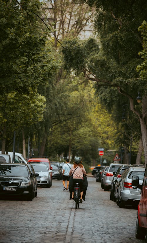 A person riding a bike down a street