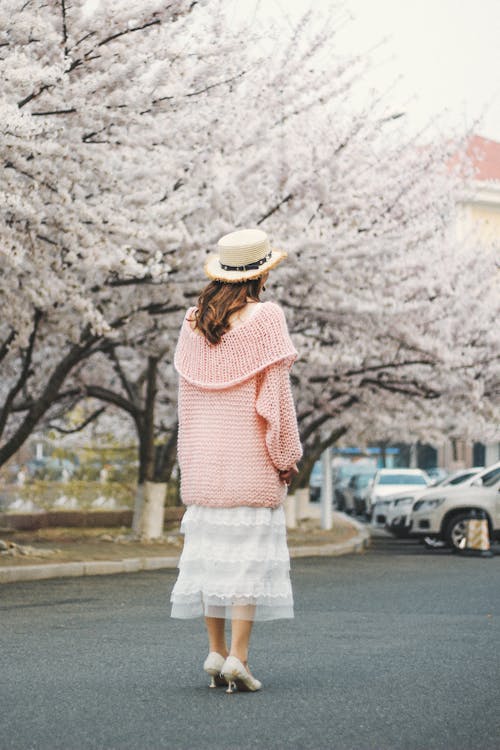 Standing Woman Wearing Pink Jacket and White Dress