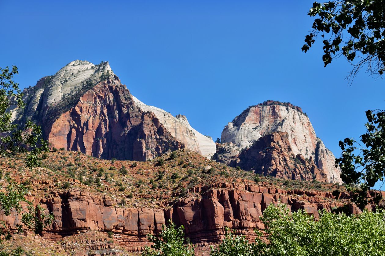 Iconic Zion National Park rock formations and cliffs under a clear blue sky in Utah