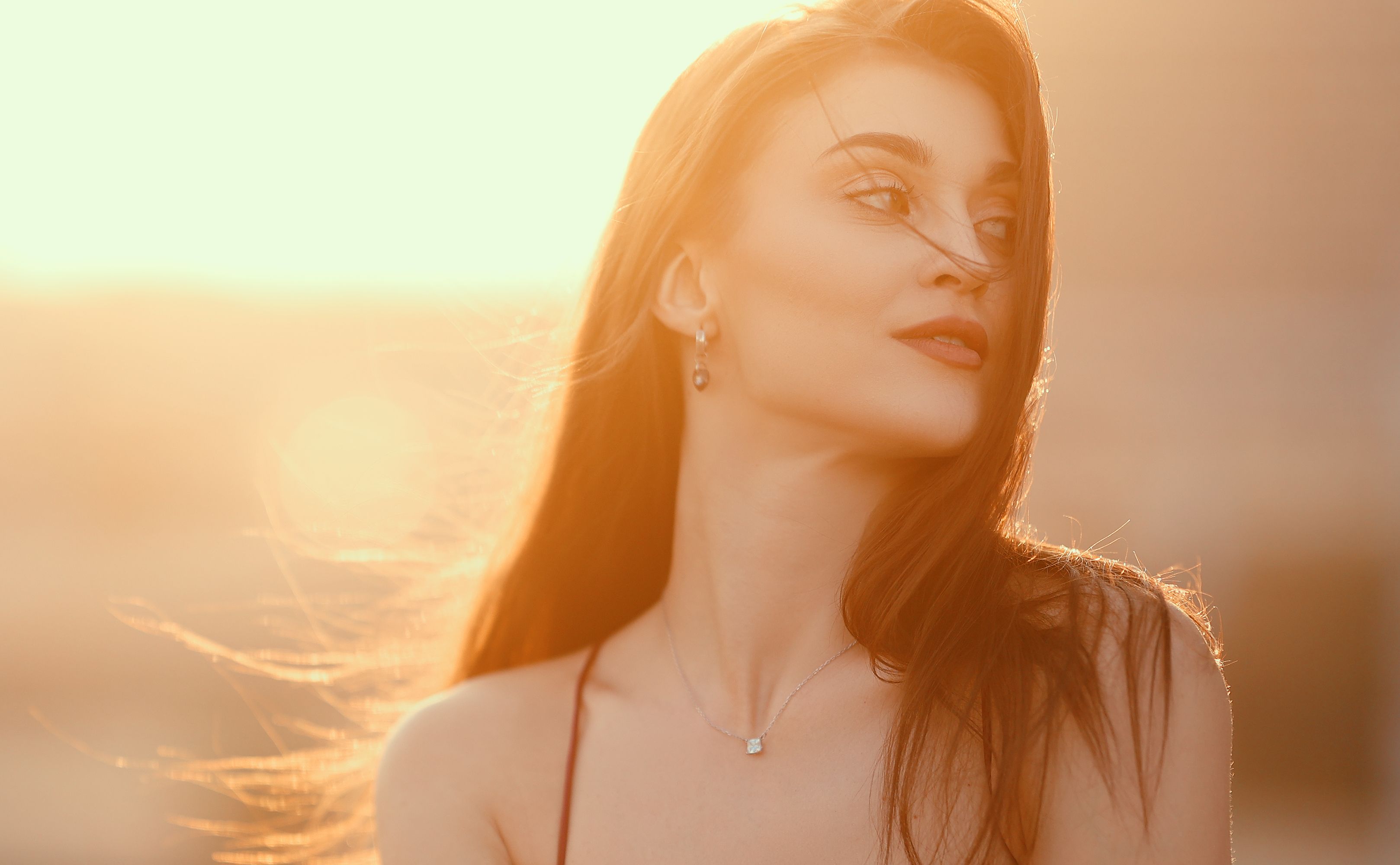 Elegant portrait of a woman in Dubai's golden sunset light.
