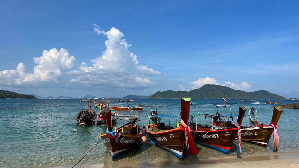 Longtail boats pulled up on a beach near Phuket