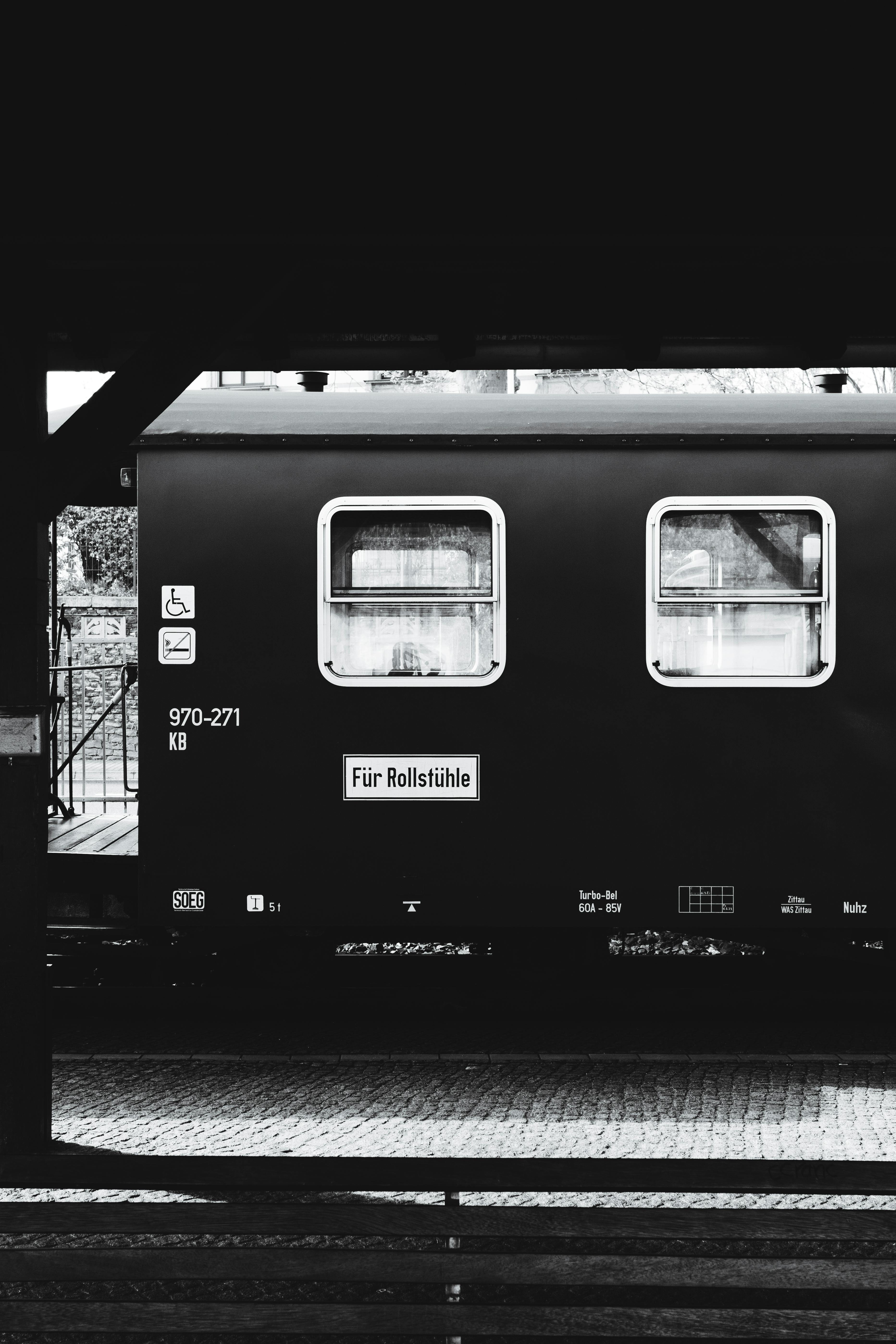Monochrome photo of a train car at Zittau station, Germany, emphasizing transportation theme.
