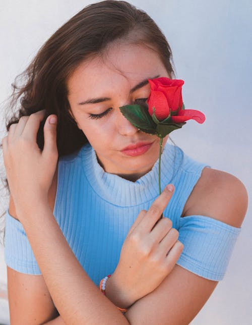Free Woman Holding A Red Rose Stock Photo