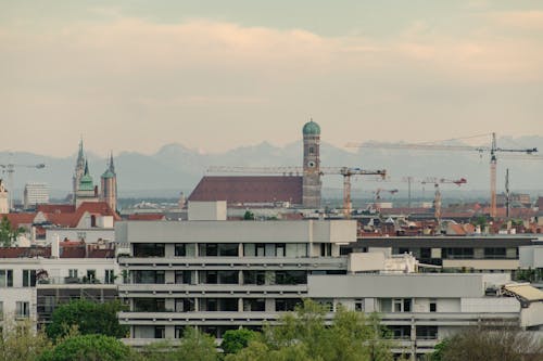 A city skyline with buildings and a mountain in the background