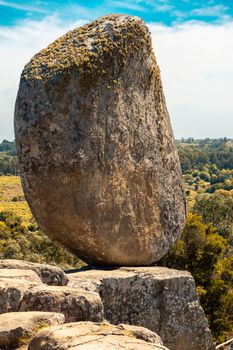 The iconic Piedra Movediza rock formation in Tandil, Argentina under a bright sky.