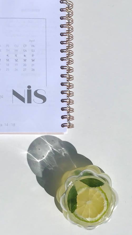 A glass of lemonade next to a calendar