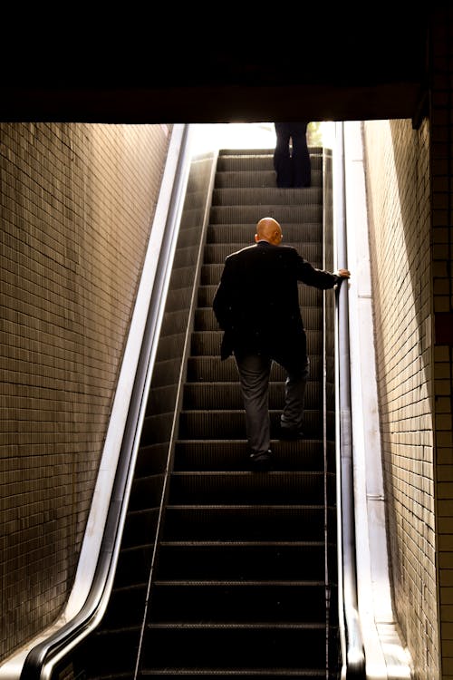 Bald Man on Escalator 