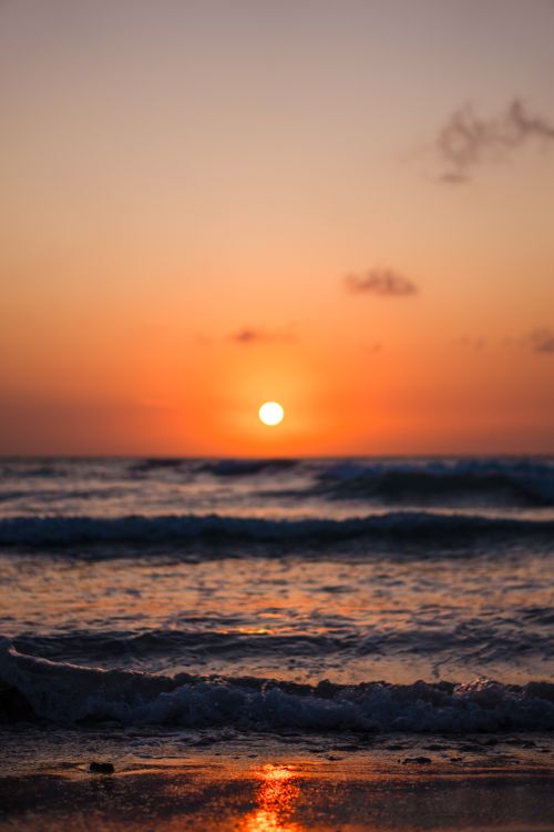 Free Beautiful sunset over the ocean at Varadero Beach, Cuba, showcasing vibrant colors and waves. Stock Photo