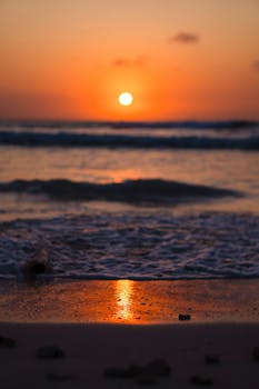 Beautiful sunset casting reflections on Varadero Beach's calm waves in Cuba.