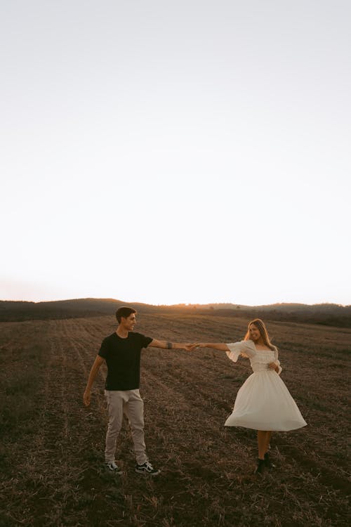 Couple on a Field During Sunset 