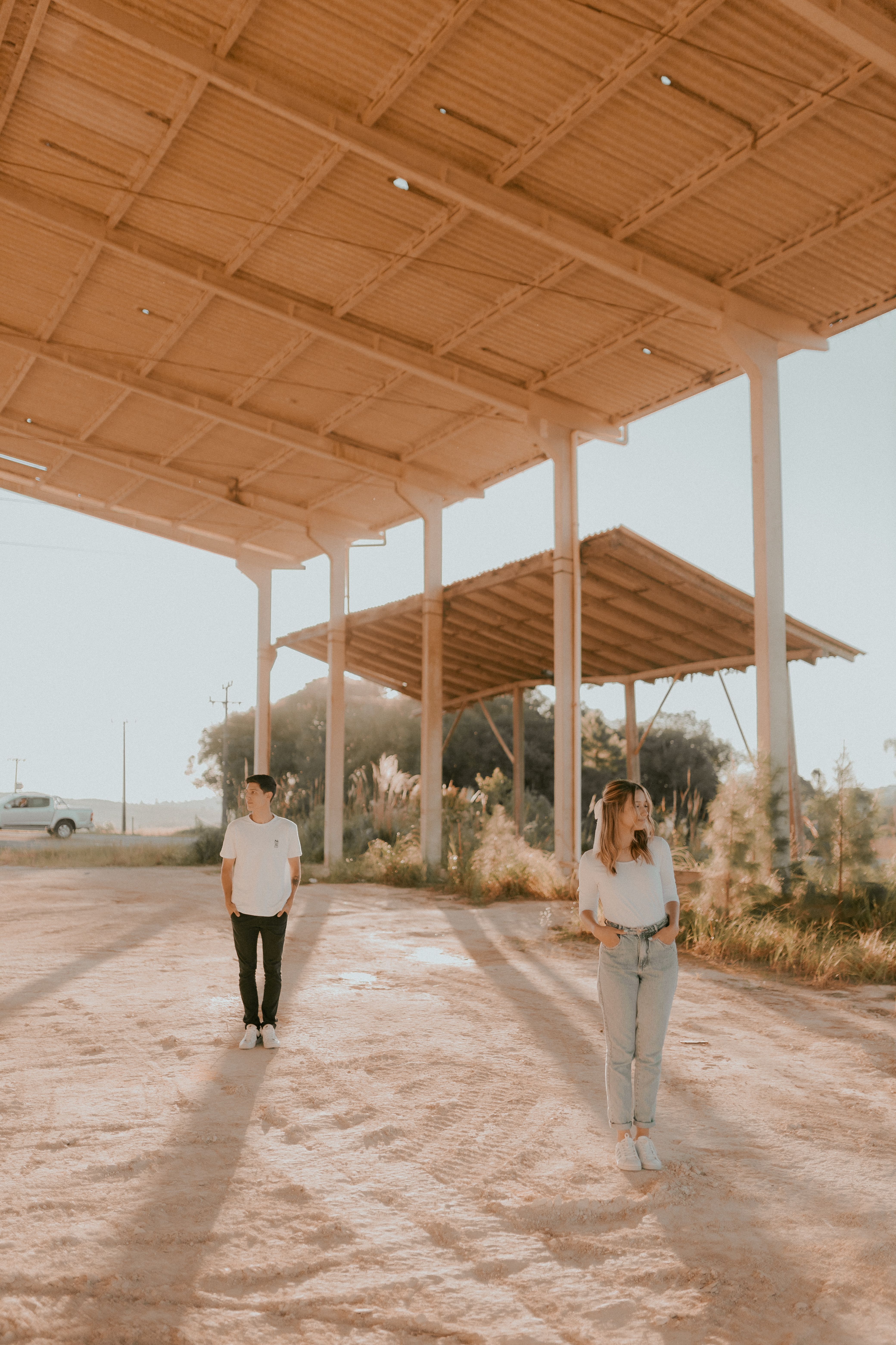 Two people walking under a covered structure · Free Stock Photo