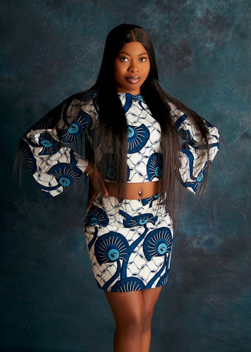 A woman in a blue and white african print skirt and top