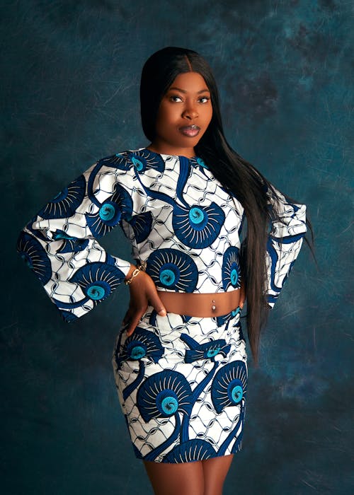 A woman in african print clothing posing for the camera