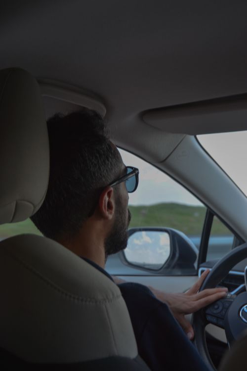 A Man in Sunglasses Driving a Car · Free Stock Photo
