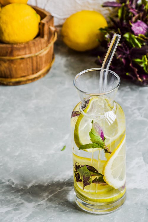 Lemonade in a glass with lemons and mint