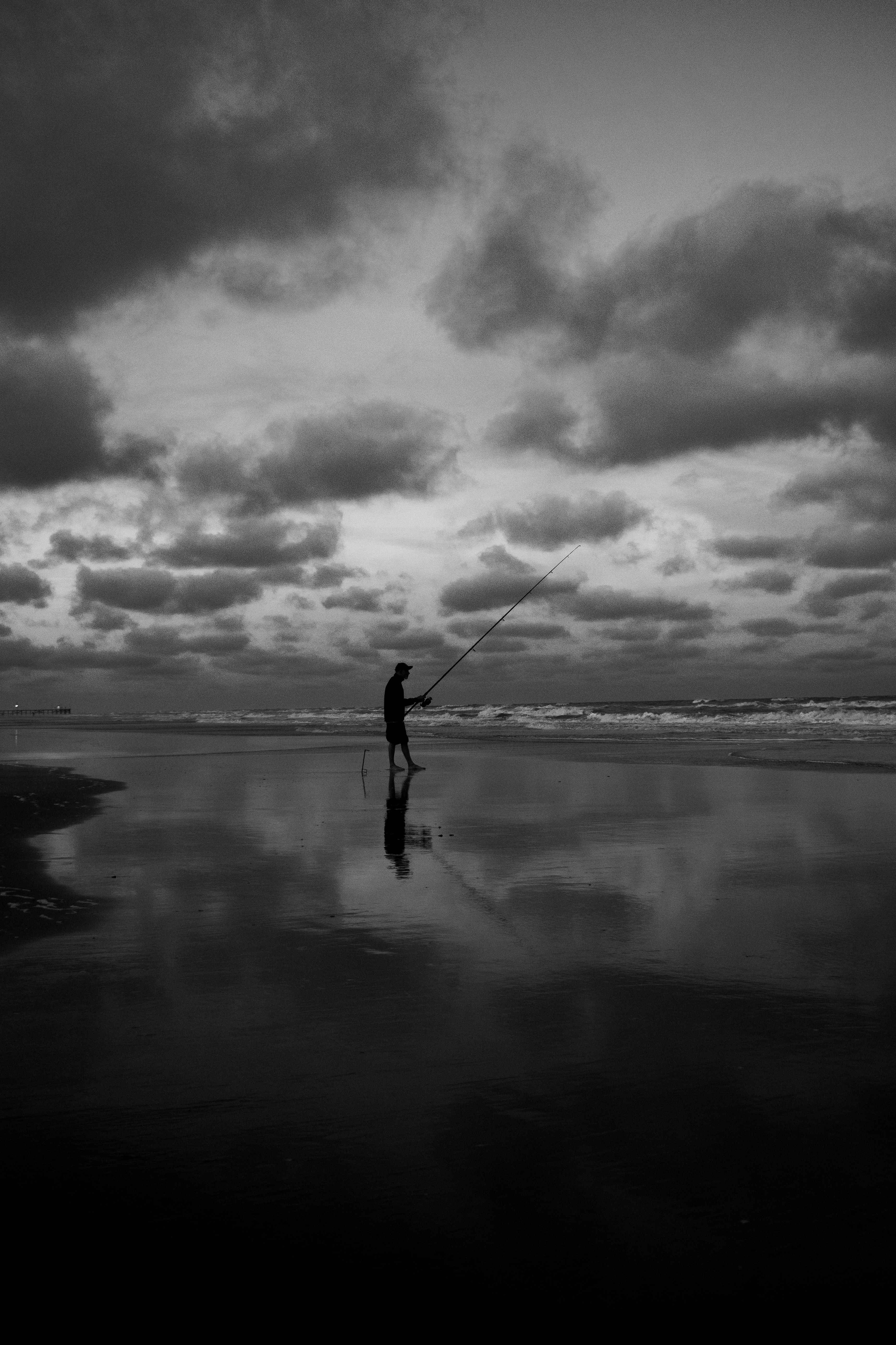 Man Fishing on Beach in Black and White · Free Stock Photo