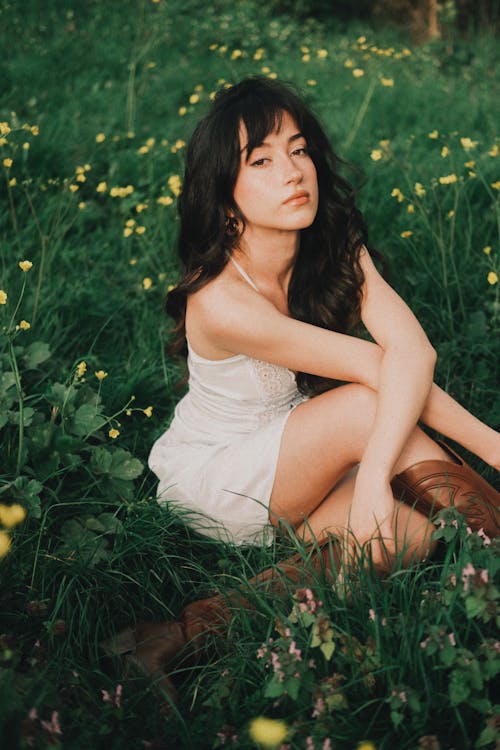 A woman sitting in a field of flowers