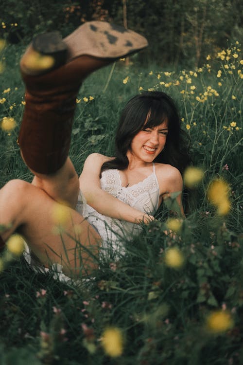 A woman laying on the ground in a field of flowers