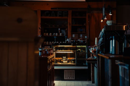 A view of a coffee shop with a counter and a coffee machine