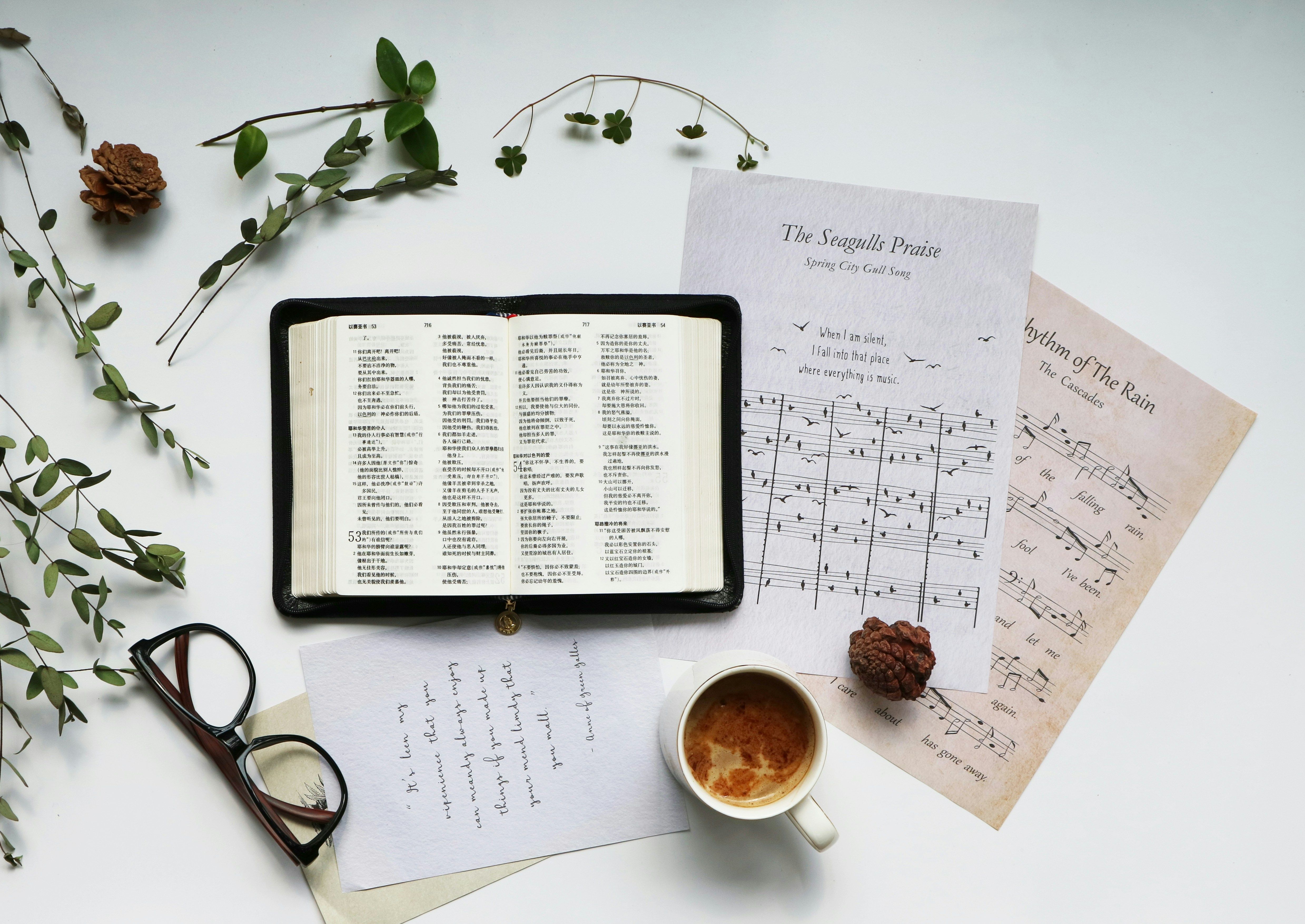 A clean desk with printed reference sheets stacked beside a ceramic coffee mug