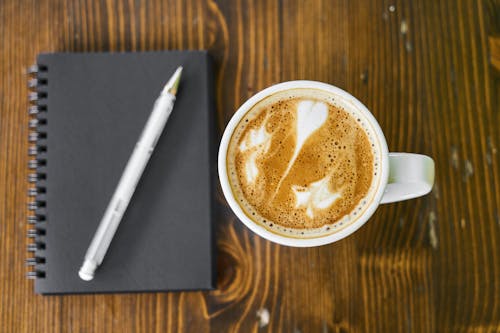 White Ceramic Mug Filled With Brown Liquid