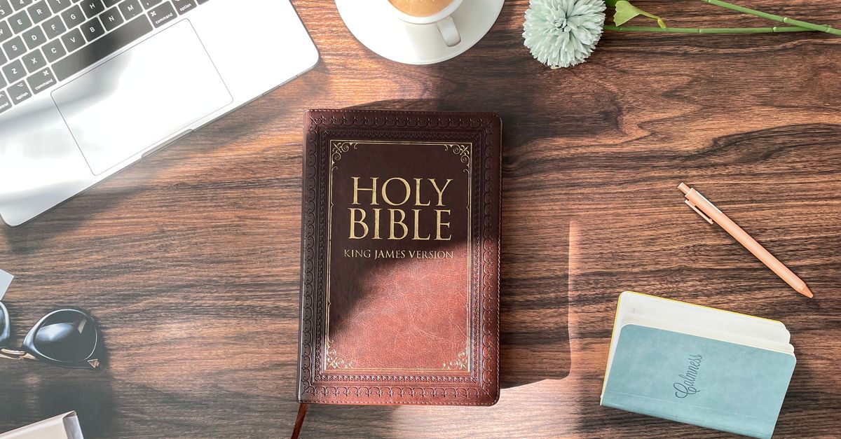 open Bible on a wooden table with morning coffee and a journal